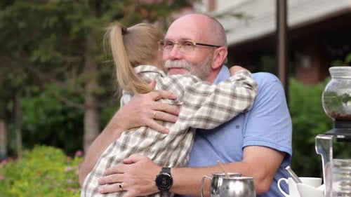 Grandfather and Child Share Loving Embrace Outdoors