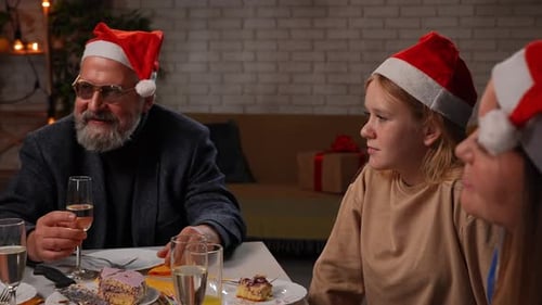 Family Celebrates Christmas with Cake and Champagne