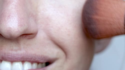 woman using on face,cheek nose under eye area large powder brush