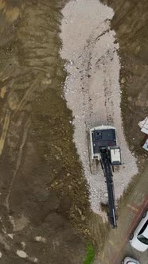 Vertical Video of Construction Site Excavator Leveling Ground for Building