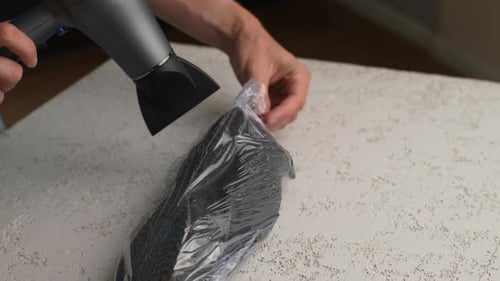 Hair Dryer Sucks Air Out of Plastic Shoe Bag