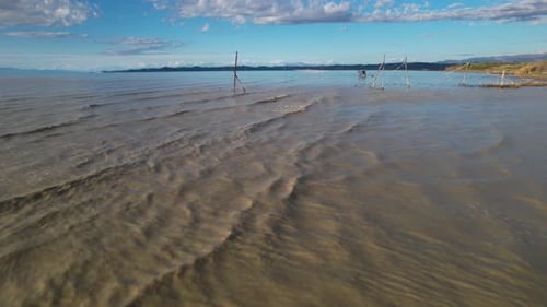 Nets hanged by rope standing on river mouth for fishing on muddy waters of river mixing with seawate