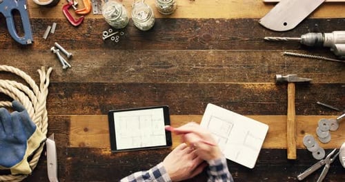 Person Drawing Plans for a Construction Project