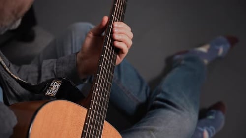 Unrecognizable Man Playing Acoustic Guitar Musician at Home Practicing Technique and Melody
