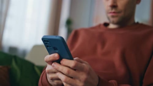Man Hands Texting Smartphone Relaxing at Couch Close Up Freelancer Messaging