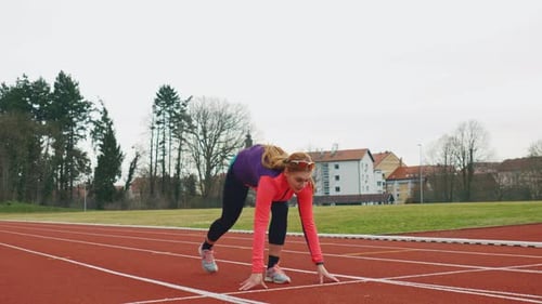 Woman Sprinting on an Outdoor Running Track