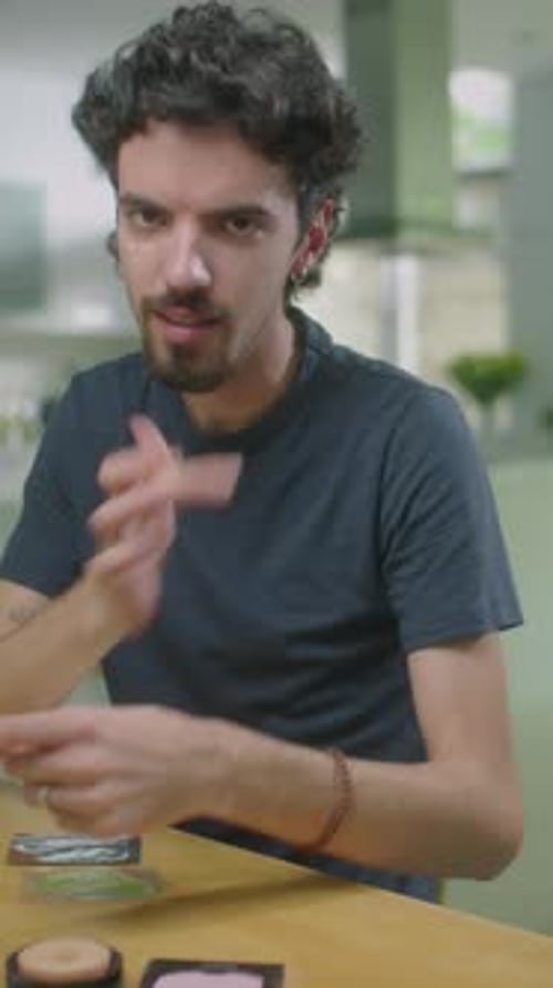Young Man Applying Makeup in Home