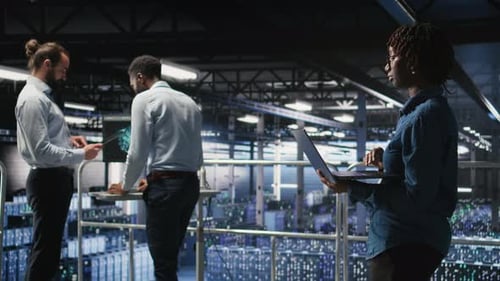 Data Center Teamworking Colleagues Running Diagnostics on Equipment