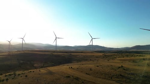 Wind Turbines Spinning on Rural Hillside
