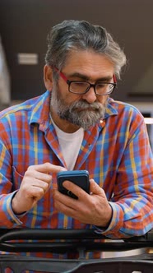 Senior Man Checking Purchased Groceries in Supermarket
