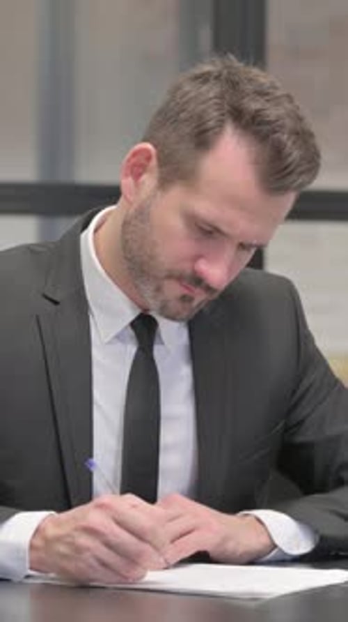 Businessman Working on Documents in Office, vertical video