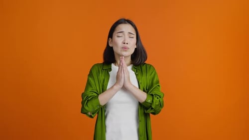 Woman Pleading, Crossing Fingers for Luck