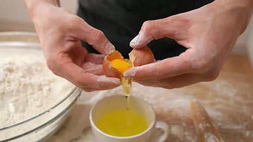 Cracking an Egg for Baking Preparation at Home