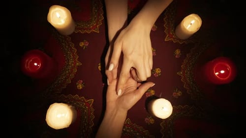 Top View Woman Chiromancer Holding a Female Clients Hand and Reading Her Lines on Open Palm