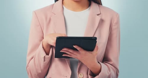 Hands, tablet and research with a business woman reading information closeup in studio on a gray