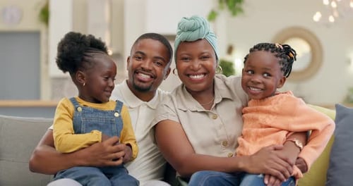 Happy Family Sitting Together on Couch at Home