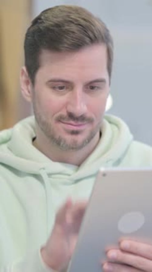 Young Man Using a Tablet Indoors