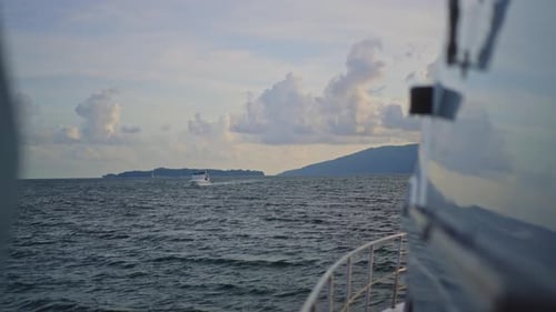 A stunning view of the vast ocean unfolds as the yacht glides smoothly, waves shimmering under the g