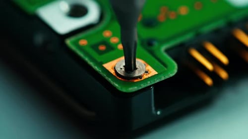 Unscrewing a Circuit Board Close Up