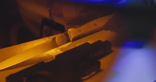 Knife and Gun Laying on Table
