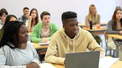 University Students Attending Lesson and Using Laptop in Classroom