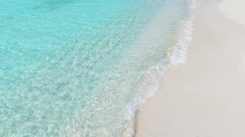 Top View of Tropical Beach with White Sand and Clear Turquoise Water in Natural Sunlight Minimalist