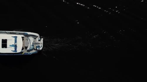 Luxurious white yacht sailing on water, top view