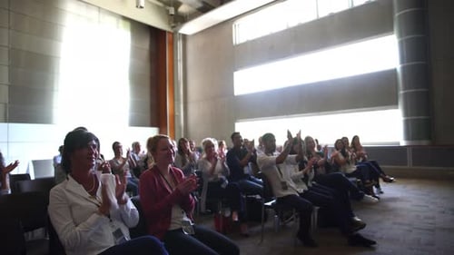 Audience Clapping at a Corporate Presentation Indoors