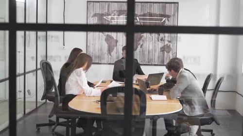 businessmen working with documents at the desk in the office by the glass