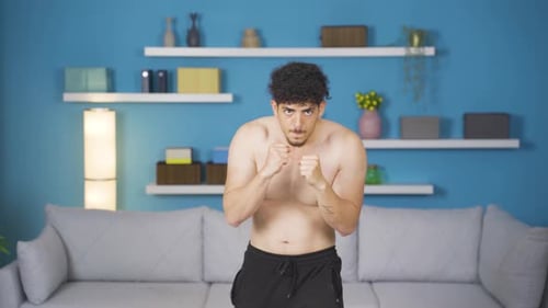 Young Man Shadow Boxing in Living Room