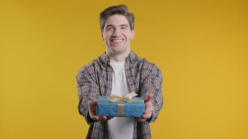 Man Presenting Wrapped Gift with Ribbon and Bow