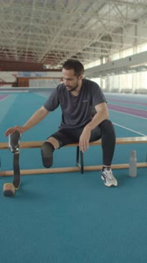 Portrait of Man with Running Blade at Indoor Stadium