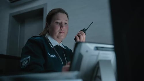 Female Security Officer or Dispatch Talks in Walkie Talkie in Monitoring Center