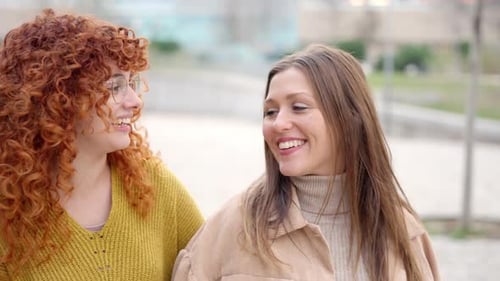 Closeup of Women Talking Happily Along the Street
