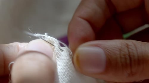 Close Up of Needle Stitching White Fabric