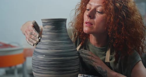 Artist Shaping Clay on Pottery Wheel