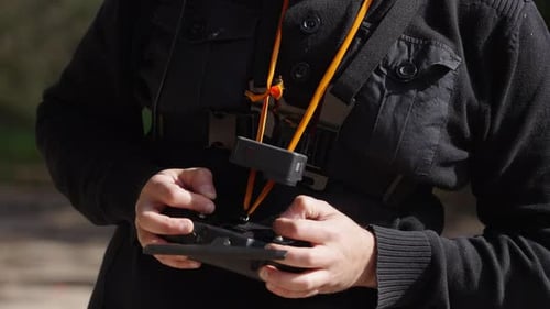 Pilot flying FPV Drone, close up of radio control