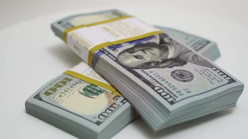 Stack of Bank Bundles with US Dollars on a White Background Closeup Shot of New Freshly Printed