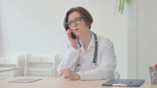 Senior Doctor Talking on Phone in Clinic