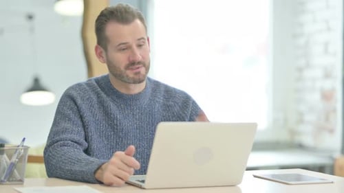 Man on Laptop Participating in a Video Call