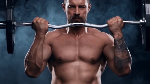 Fit and Sporty Bodybuilder Over Black Background Bodybuilder Training Using Barbell The Concept of