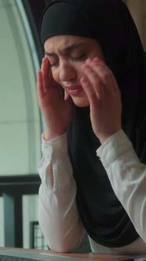 Woman Experiencing Headache While Working at Laptop