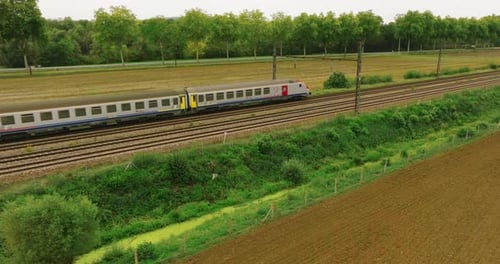 Aerial View of Fast Passenger Train Driving on Railroad