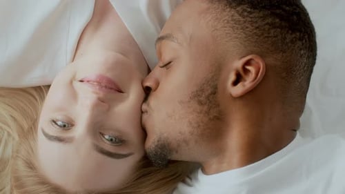 Loving Couple Relaxing Together on Bed