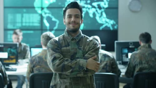Portrait of Officer in Uniform in Monitoring Room filled with Displays on Military Base