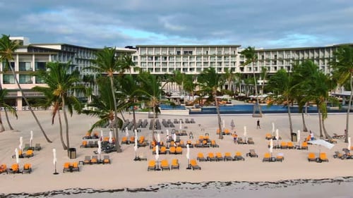 Sun chairs, sunloungers on tropical beach with white sand and palm trees, paradise Caribbean destina