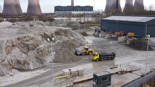 Aerial view lorry waiting for earthmover load on British industrial power station coal operation sit