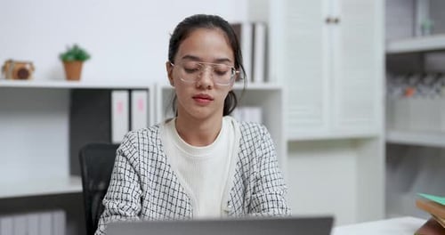 Woman Working on Laptop at Desk Indoors