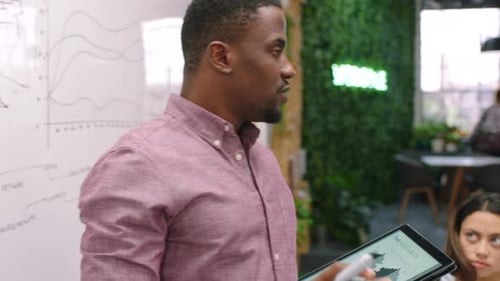 Black man leader, team and whiteboard, data analysis and graphs with marketing analytics
