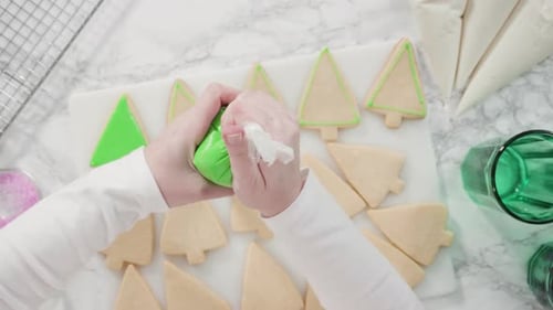 Decorating Christmas Tree Cookies With Green Icing